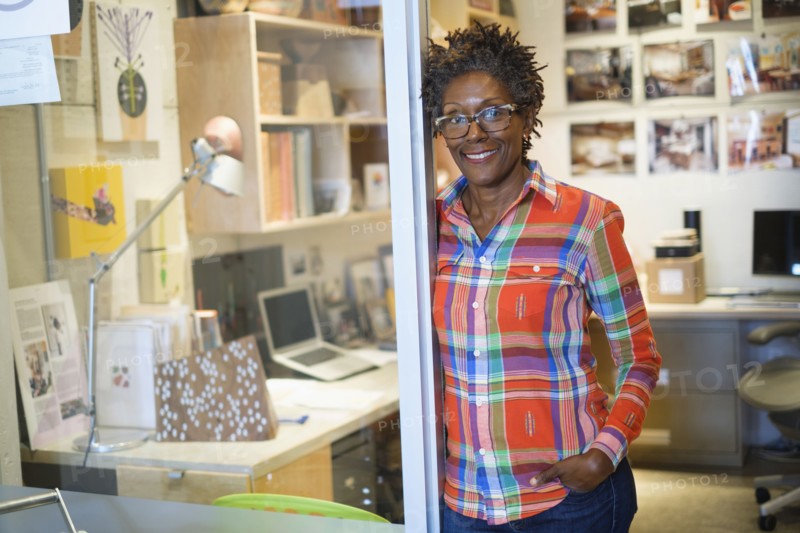 Cheerful woman standing in office.