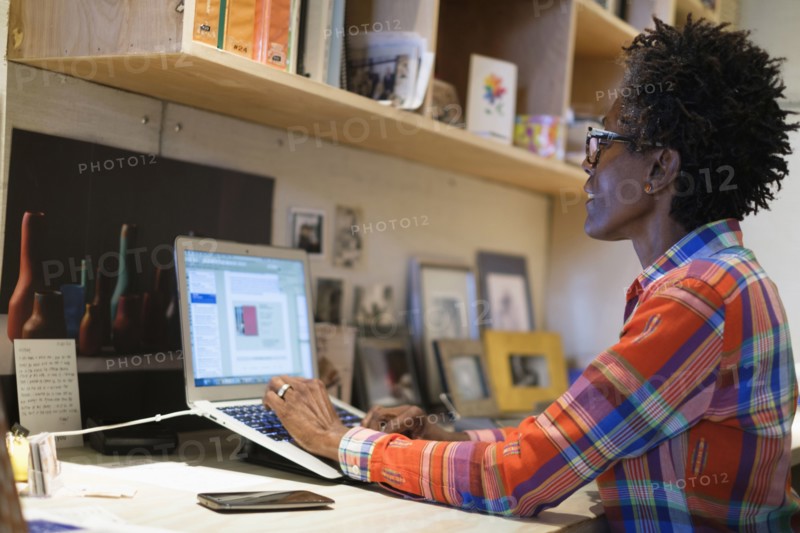 Woman using laptop in office.