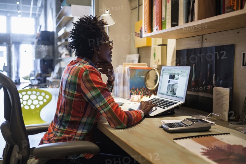 Woman using laptop in office.