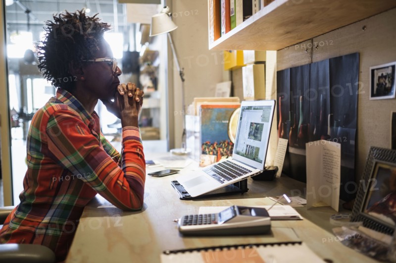 Woman using laptop in office.