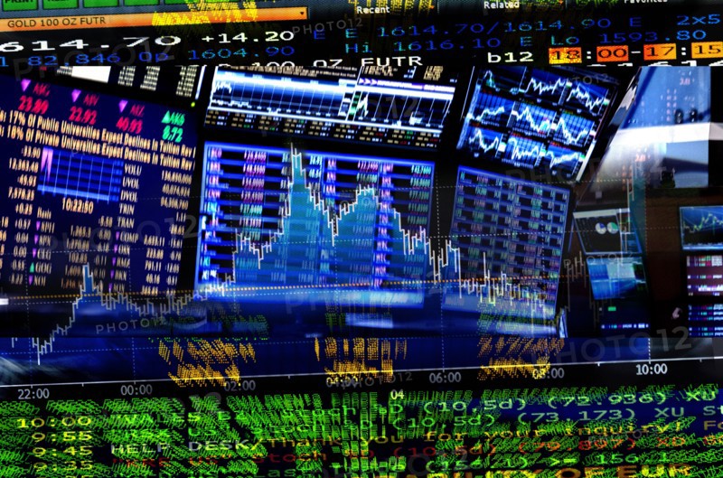 Financial figures on screens.