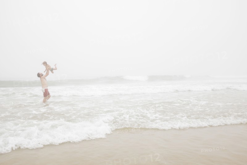 USA, New York, Monatuk, Father and daughter (2-3) on beach by ocean