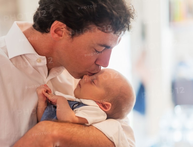 Father kissing baby son (0-1 months)
