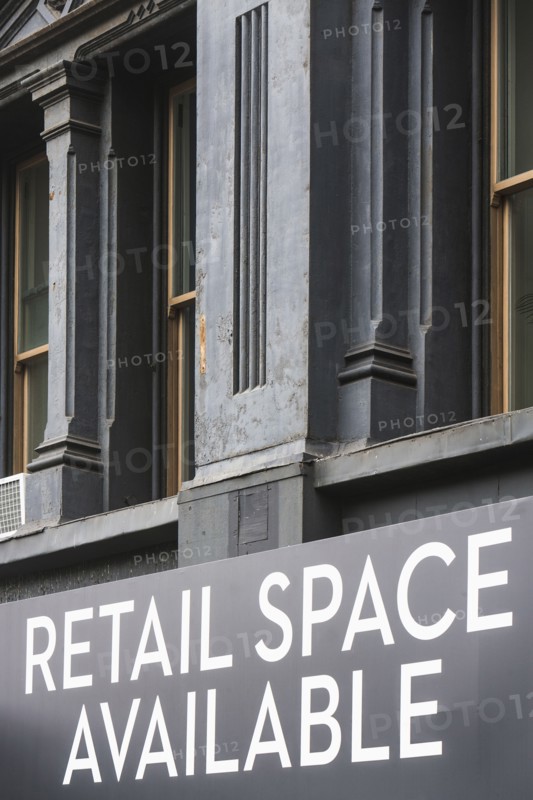 Close-up view of building facade with rental sign