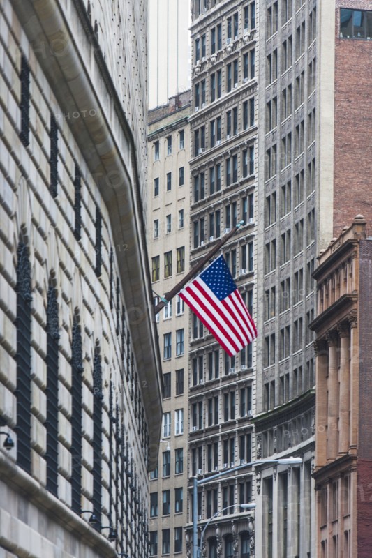 USA, New York State, New York City, Manhattan, Wall Street, American flag among skyscrapers