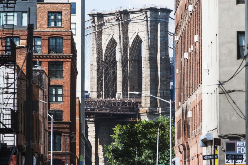 USA, New York State, New York City, Brooklyn Bridge arches seen from between buildings
