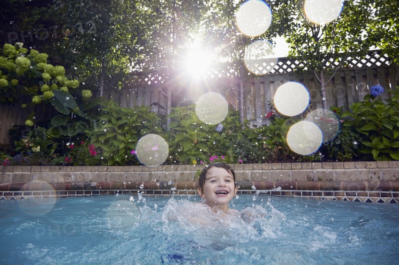 Boy (4-5) playing in pool