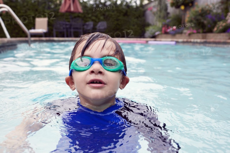 Boy (4-5) playing in pool