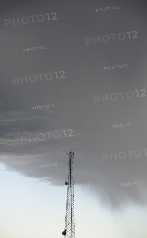 Storm clouds gathering above communications tower
