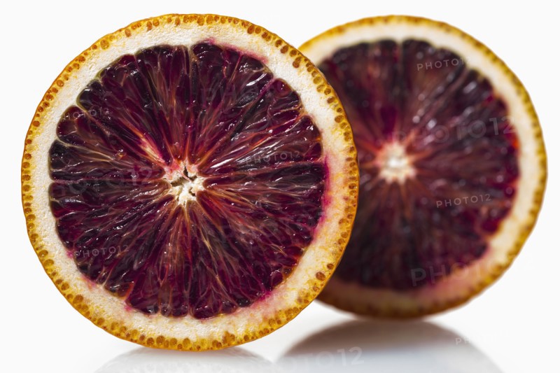 Two halves of red orange against white background
