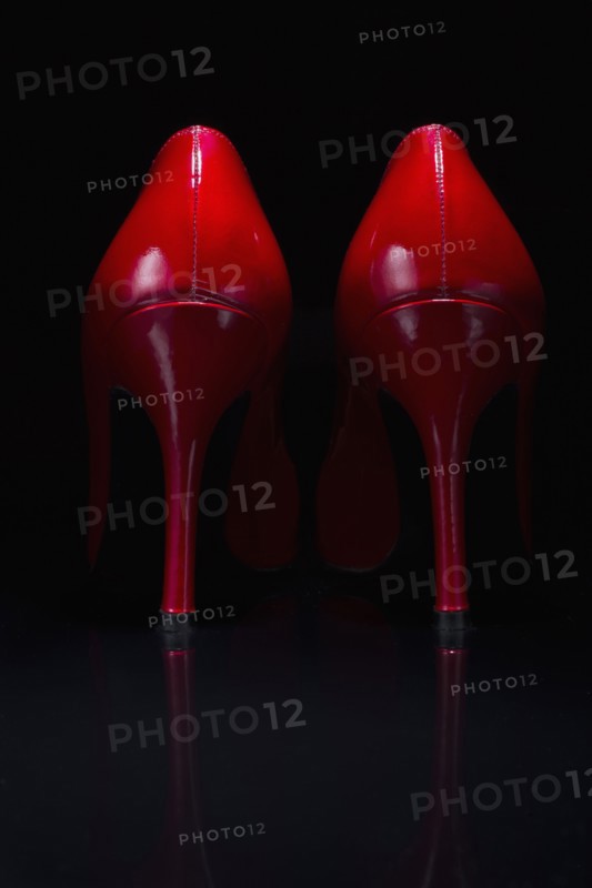 Red shoes against black background