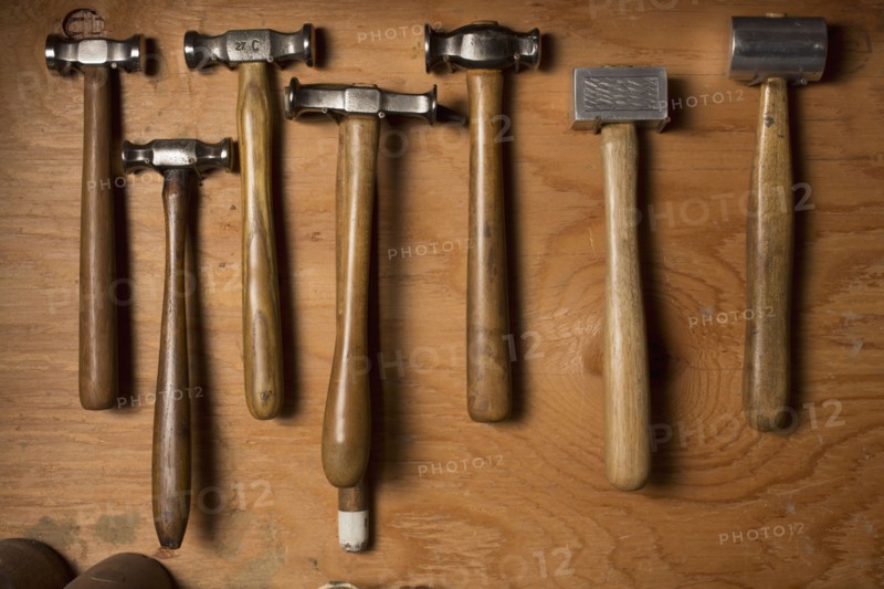 Collection of hammers lying on wood