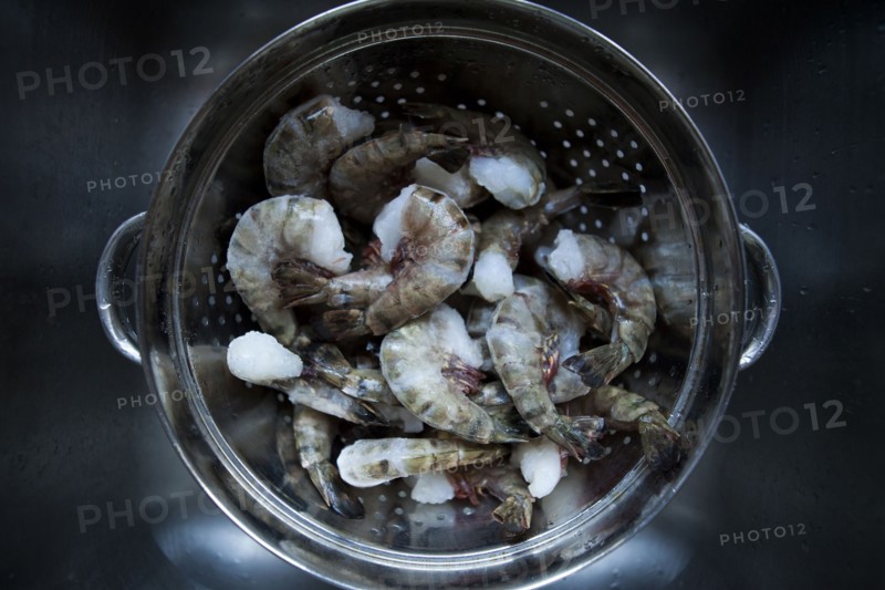Frozen prawns in metal colander