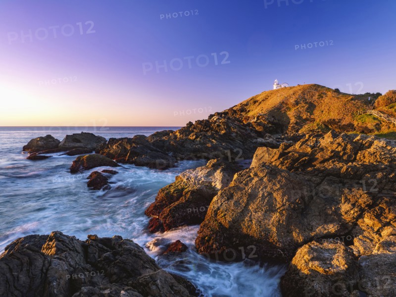 Australia, New South Wales, Port Macquarie, Lighthouse on rocky coat at sunrise