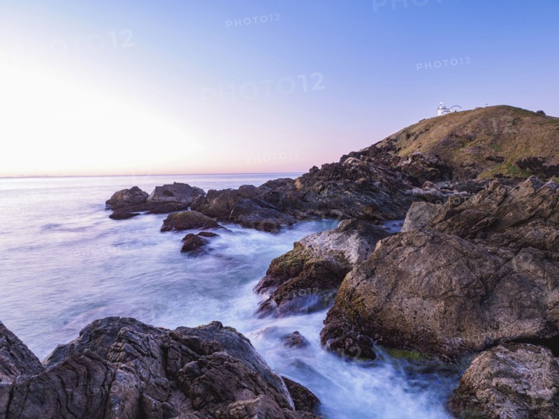 Australia, New South Wales, Port Macquarie, Lighthouse on rocky coat at sunrise