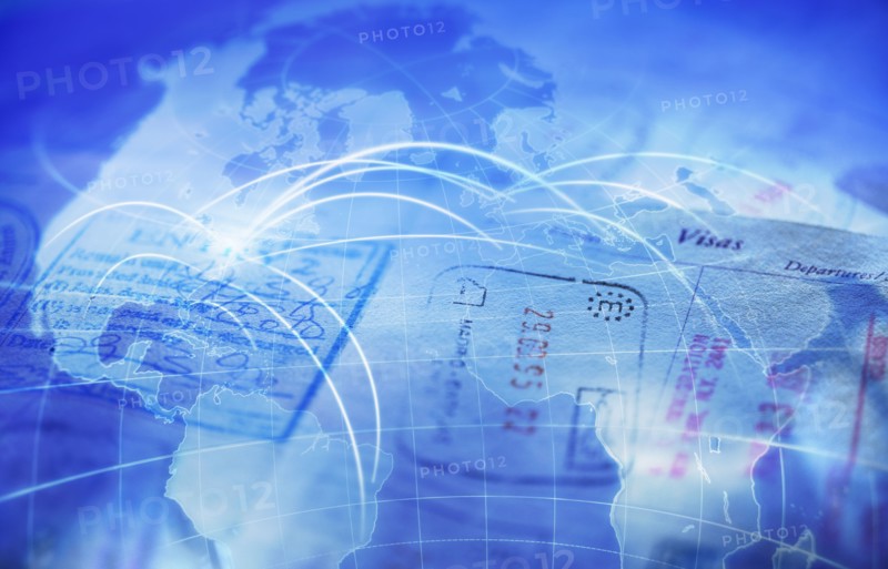 Composite image of passport and map with glowing rays.