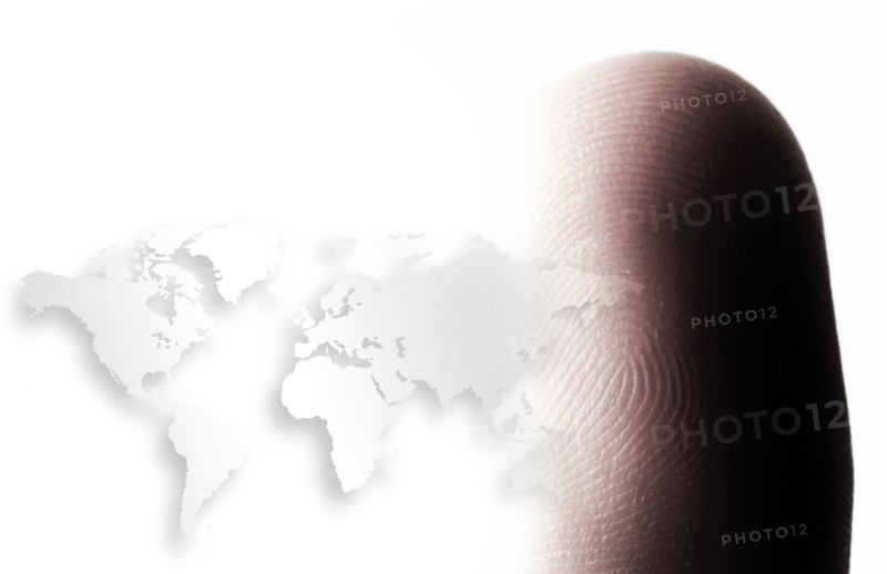 World map outline and human finger.