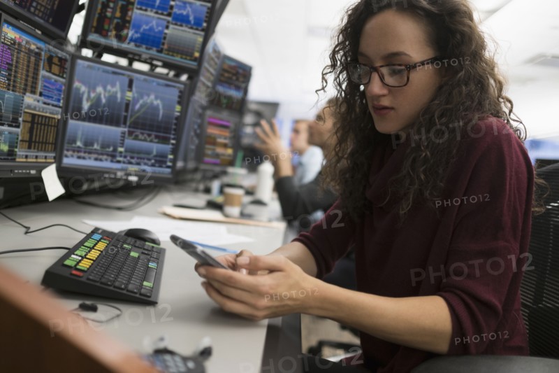Young trader using mobile phone.
