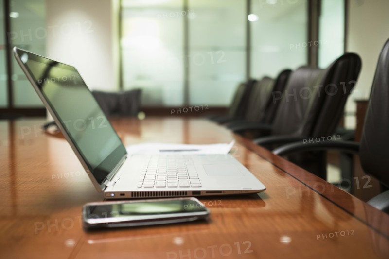 Empty conference table with mobile devices.