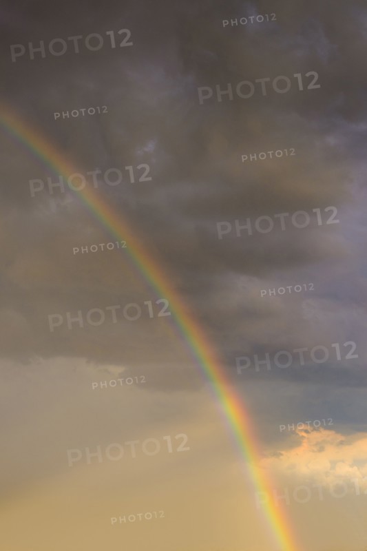 Rainbow against clouds in sunlight.