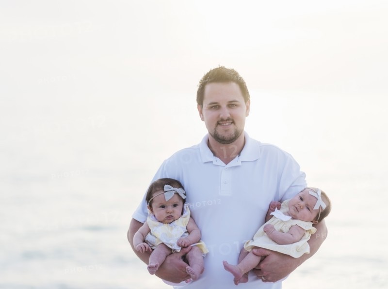 Happy father holding babies (2-5 months)