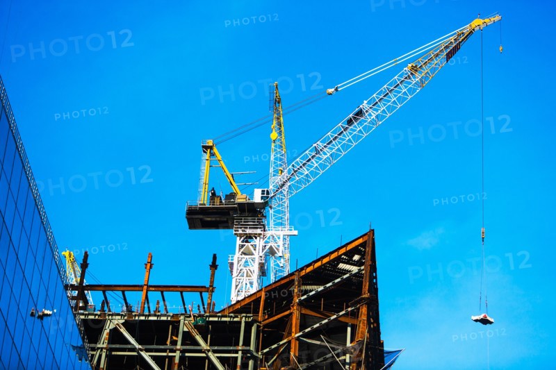 Crane at construction site against clear sky
