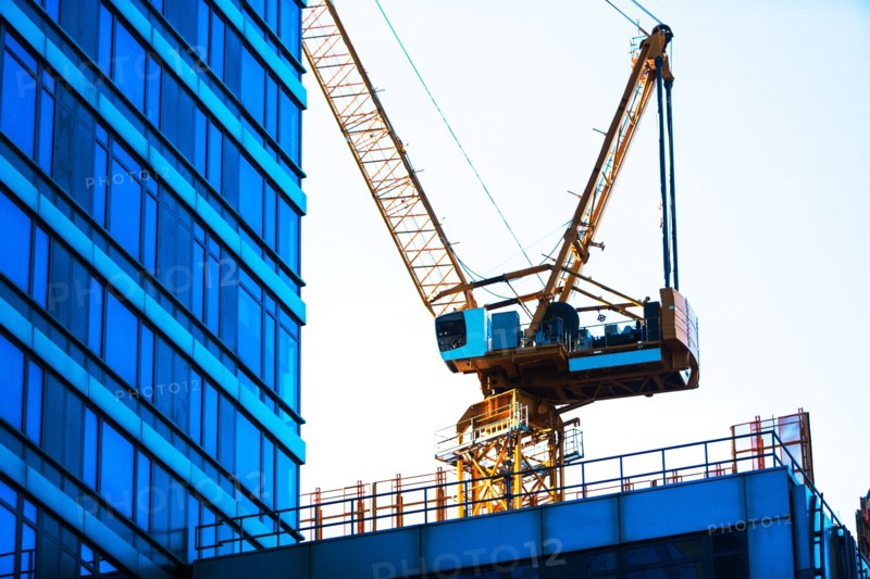 USA, New York, New York City, Crane with office building in foreground