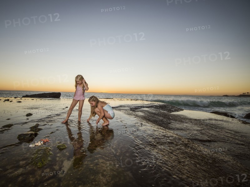 Girls (6-7,8-9) playing on beach