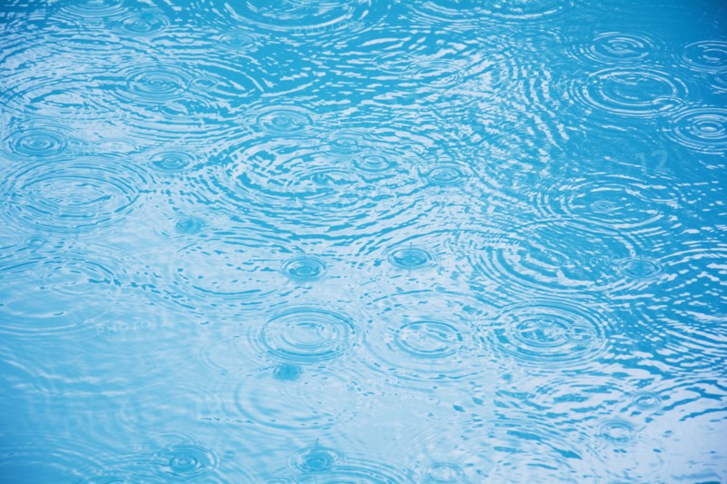 Raindrops on puddle