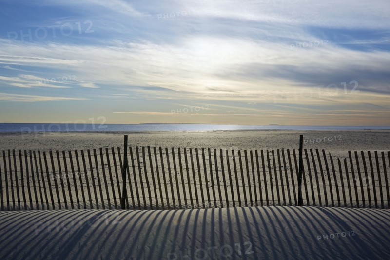 USA, New York, Lond Island, Fence by beach at sunset