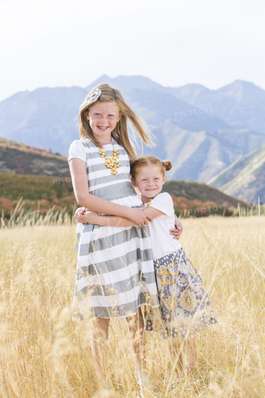 USA, Utah, Provo, Two girls (4-5, 8-9) standing in field