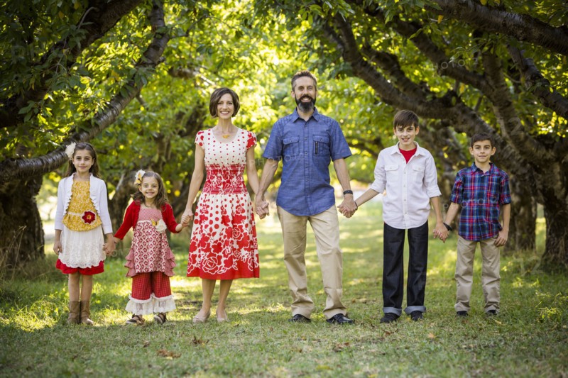 Family standing, holding hands