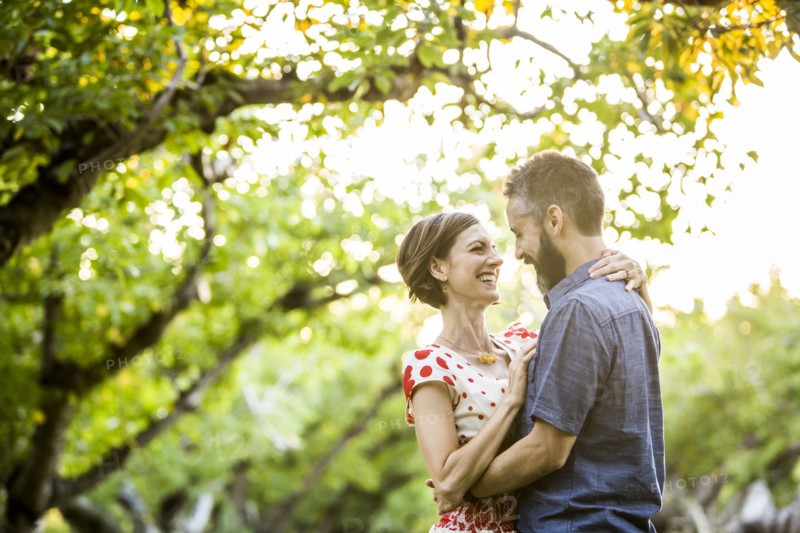 Couple embracing in cherry orchard