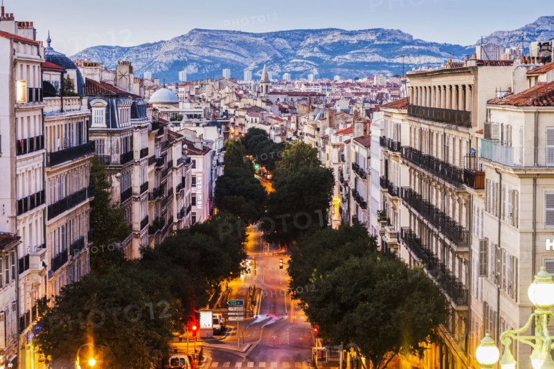France, Provence-Alpes-Cote d'Azur, Marseille, Street in city, mountain in background
