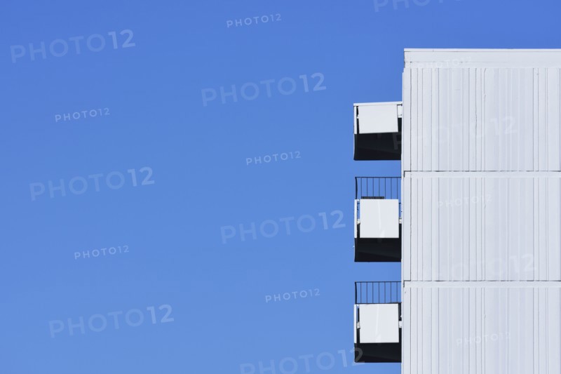 Apartment building against clear blue sky