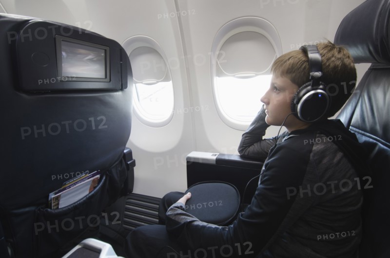 Boy watching tv in aero plane