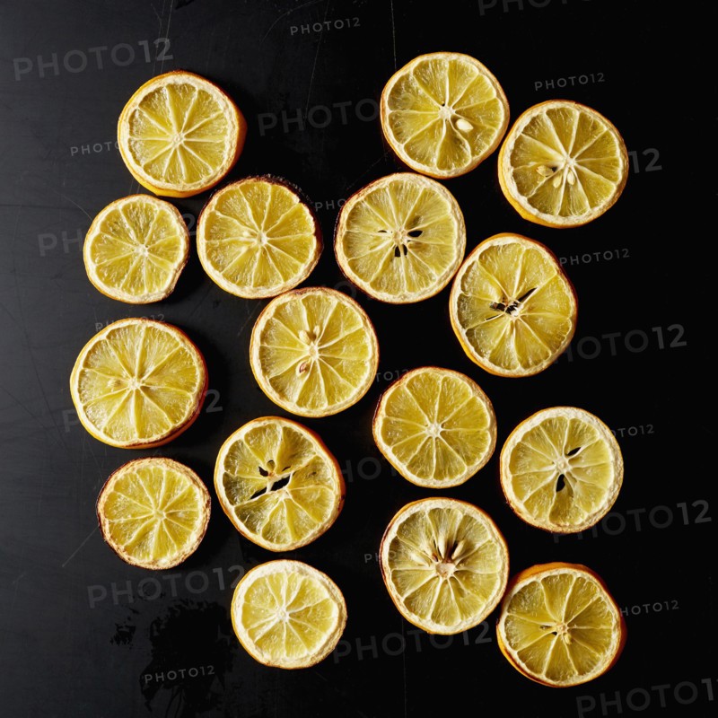 Dried lemon slices on black background
