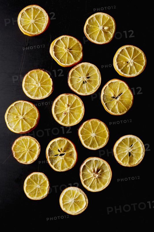 Dried lemon slices on black background