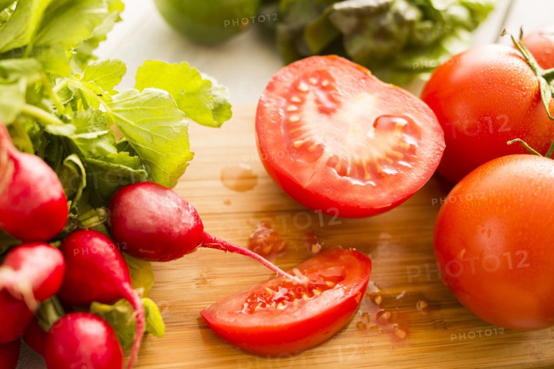 Tomato and radish on cutting board