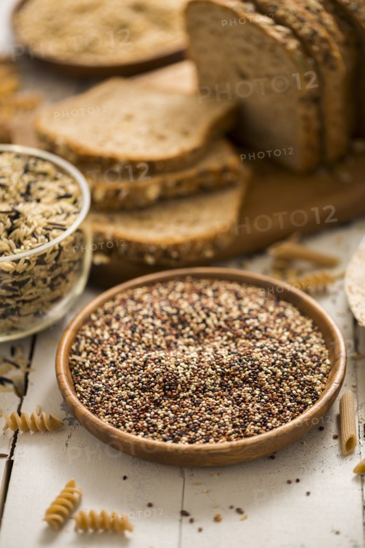 Quinoa in bowl and sliced brown bread in background
