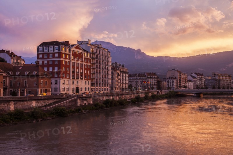 France, Auvergne-Rhone-Alpes, Grenoble, Grenoble architecture along Isere River seen at sunset