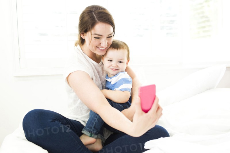 Mother taking selfie with son (4-5)