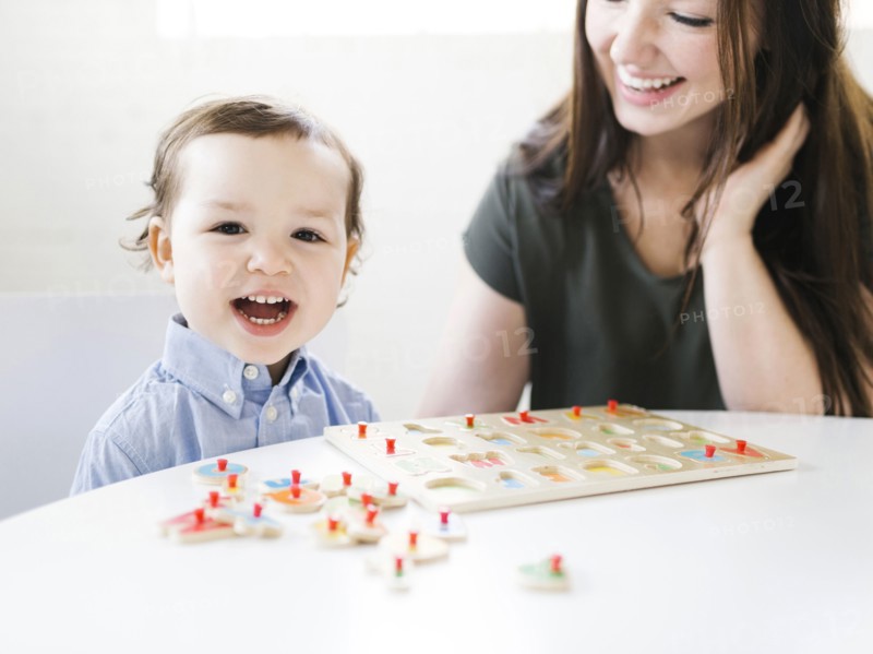 Mother playing alphabet game with son (4-5)