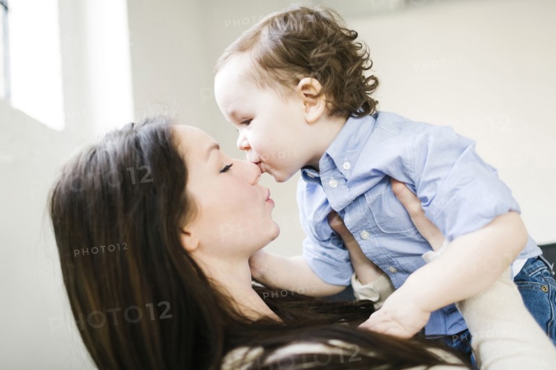 Son (4-5) kissing mother's nose