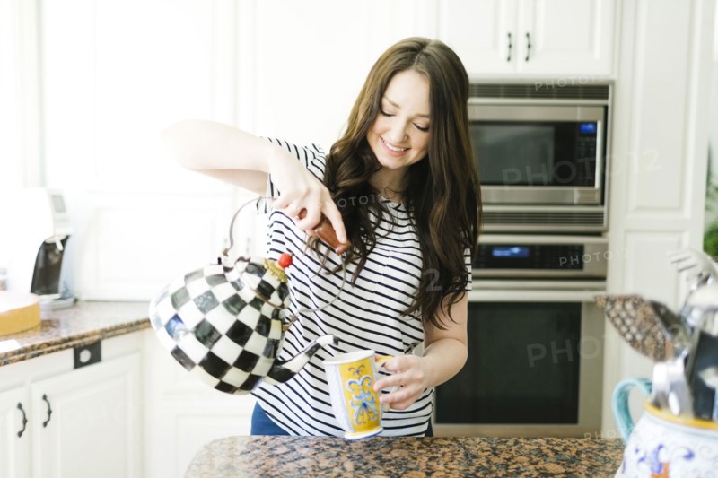 Woman pouring water from teapot
