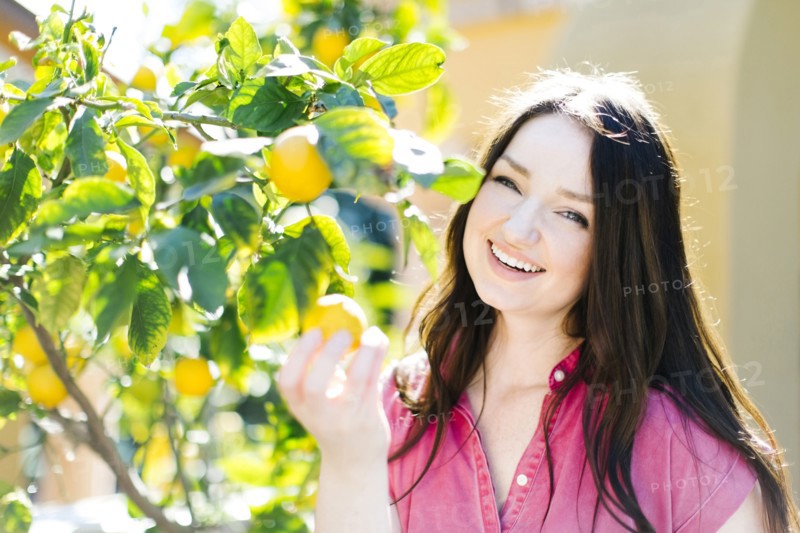 Woman picking oranges
