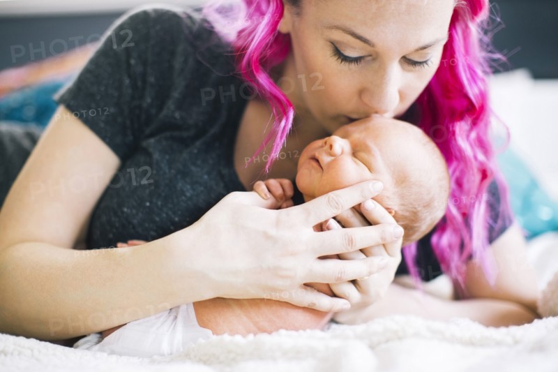 Mother holding newborn son (2-5 months)