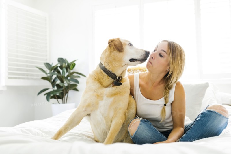 Portrait of blond woman with golden retriever