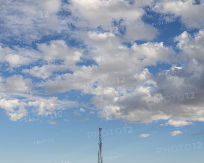 White clouds over communications tower