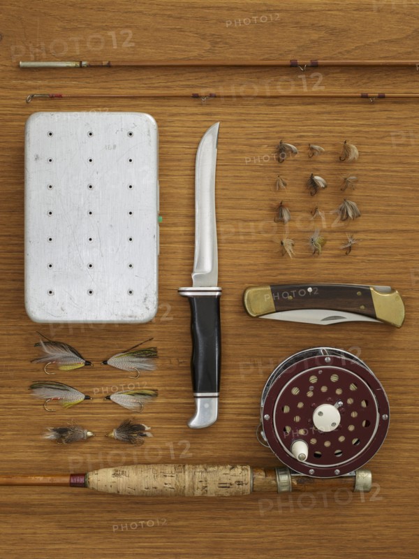 Studio shot of flyfishing equipment on wooden table
